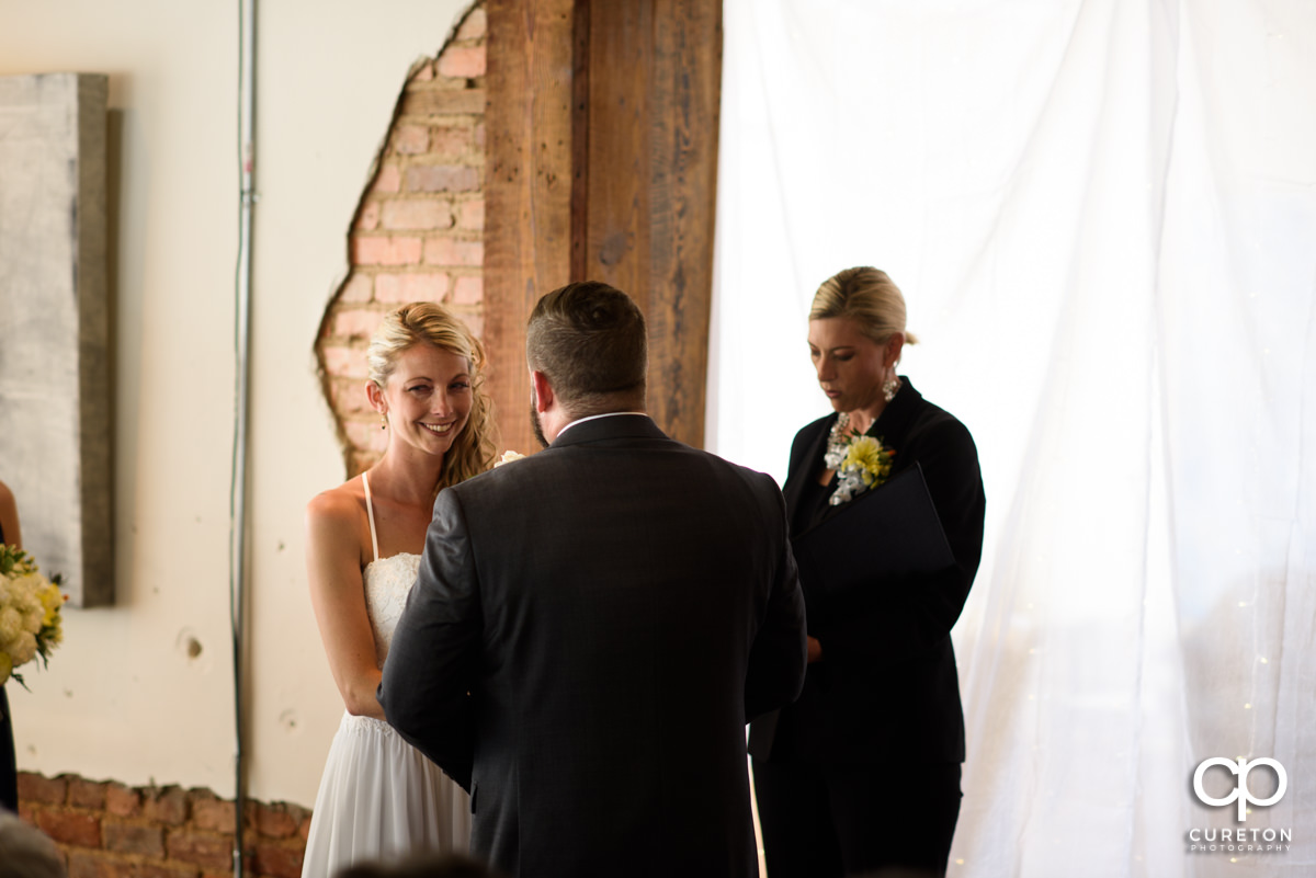 Bride smiling during the wedding ceremony.