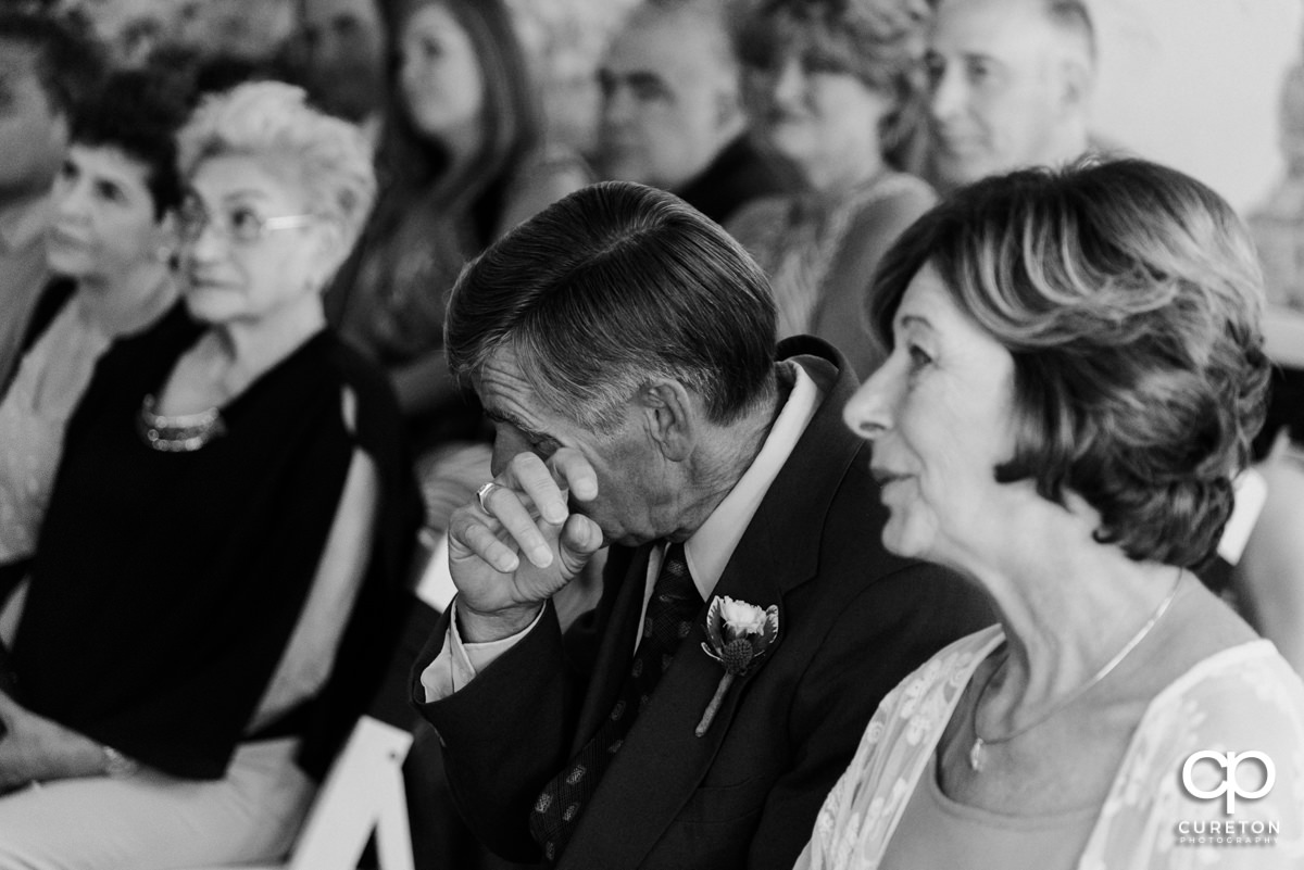 Bride's father crying during the wedding ceremony.