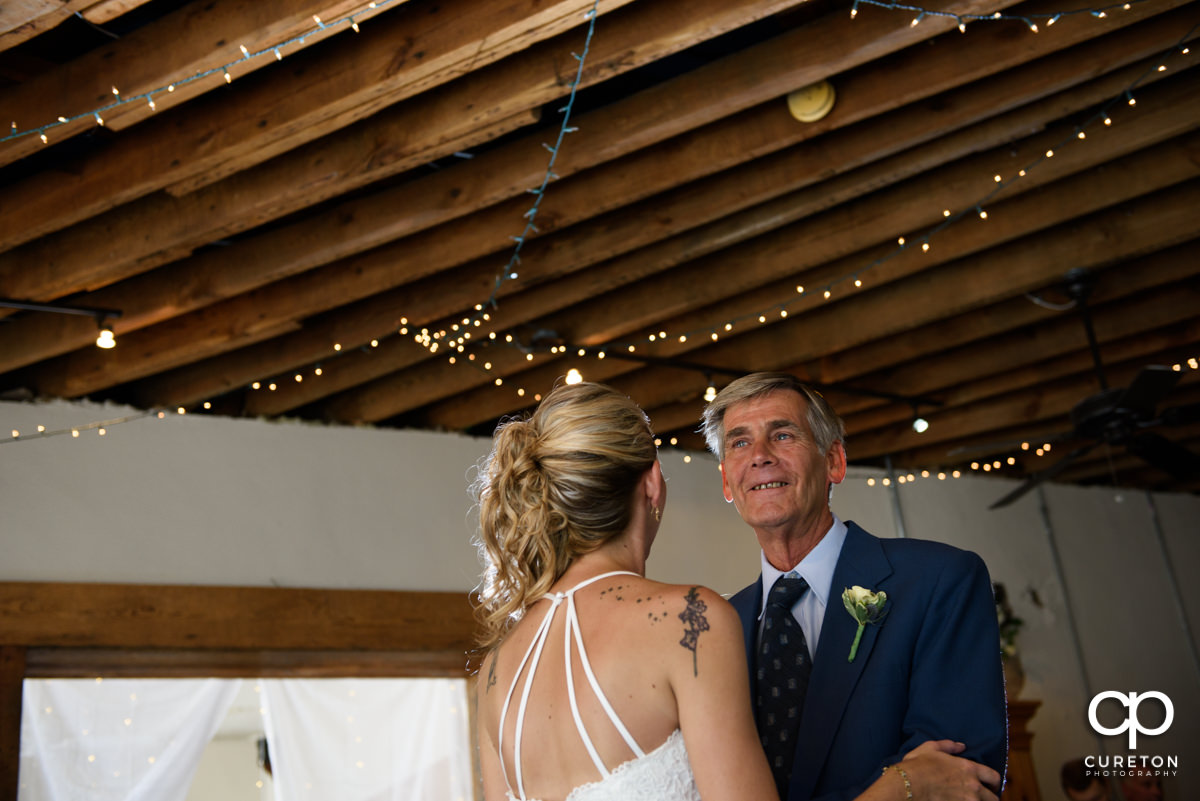 Bride sharing a dance with her father at the wedding reception.