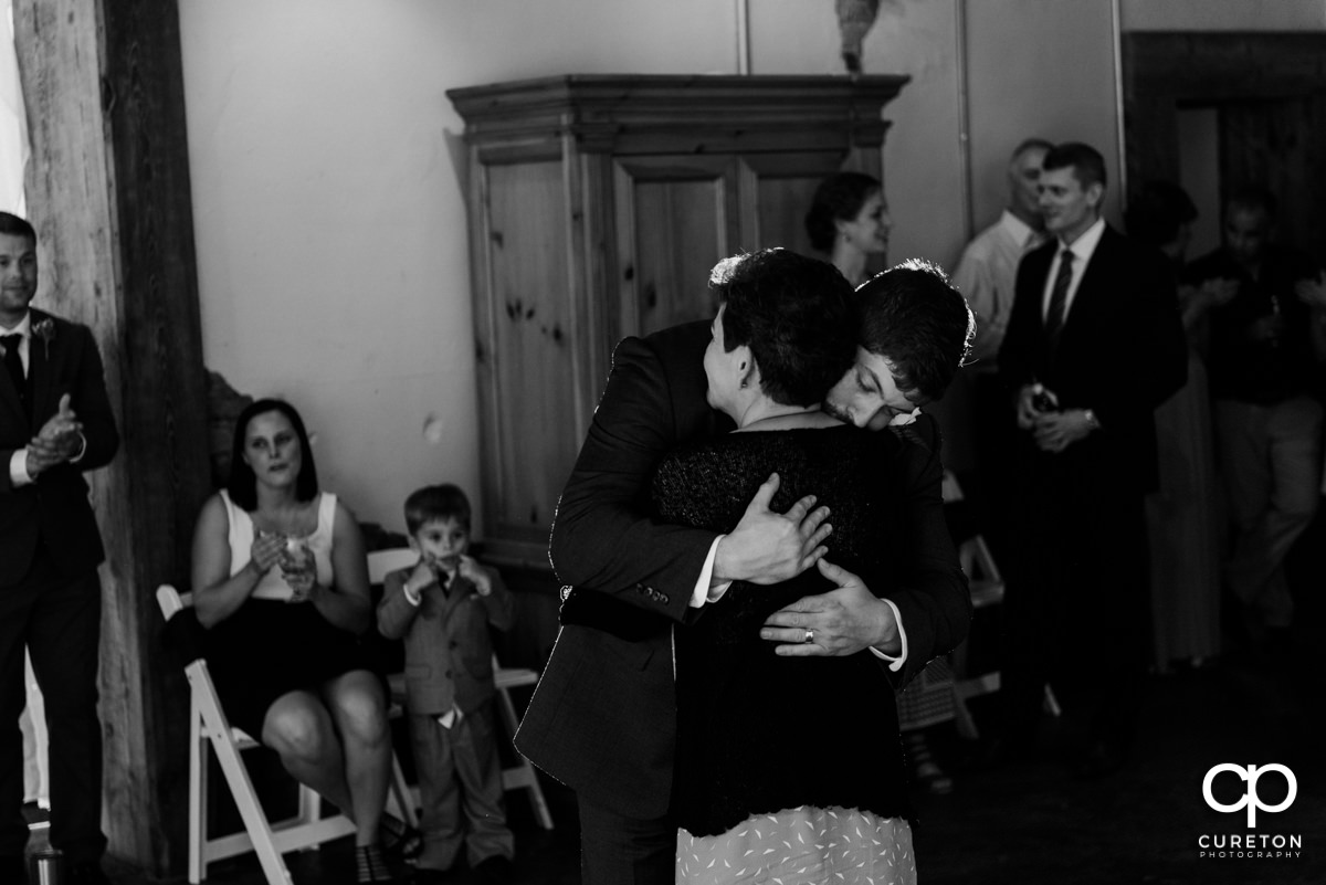 Groom hugging his mother.