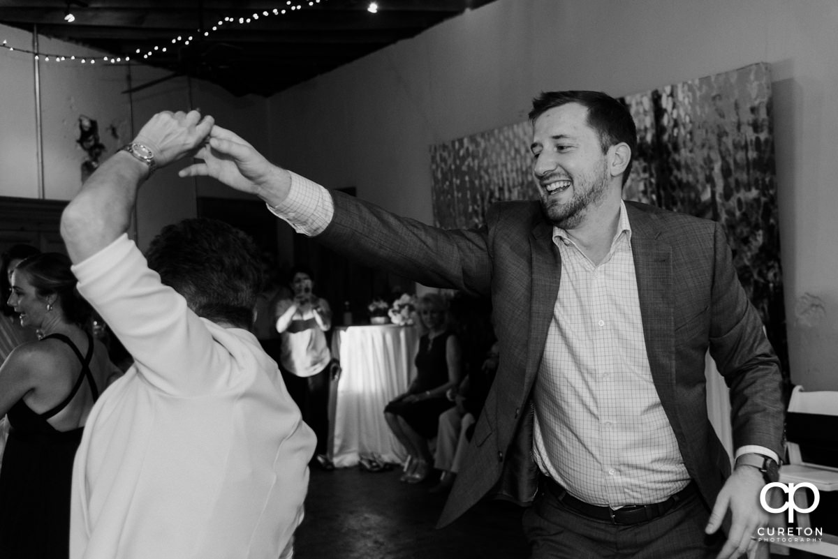 Wedding reception guests dancing at Artisan Traders.