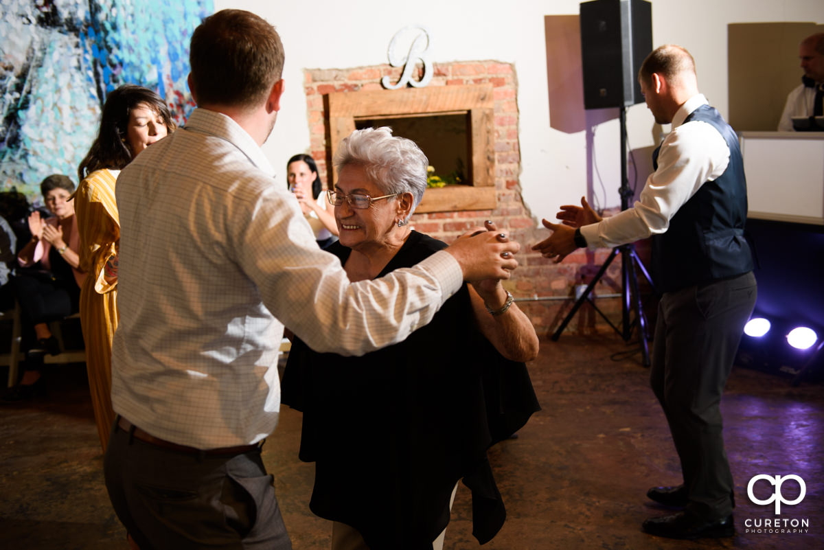 Wedding reception guests dancing at Artisan Traders.