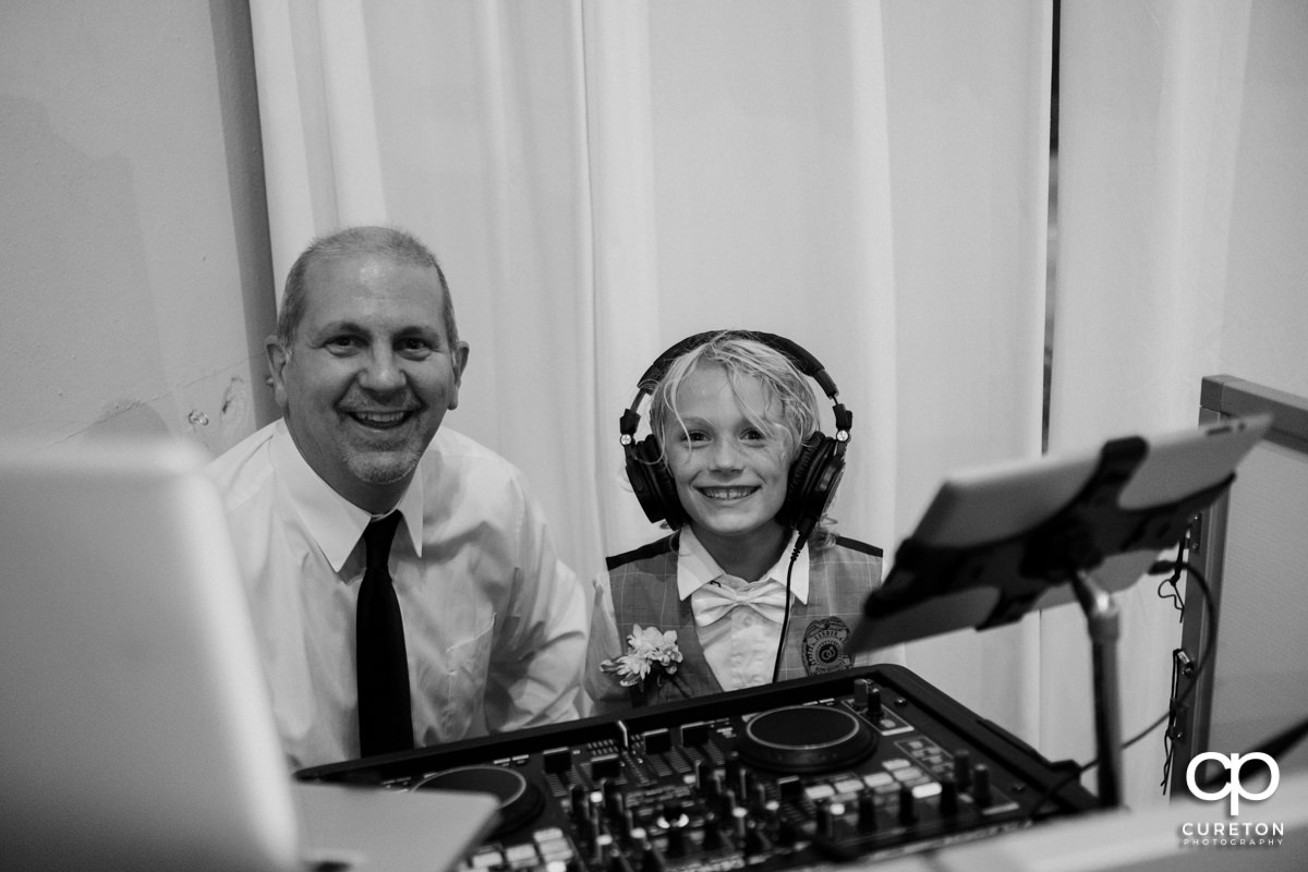 Son of the bride with headphones on in the DJ booth.