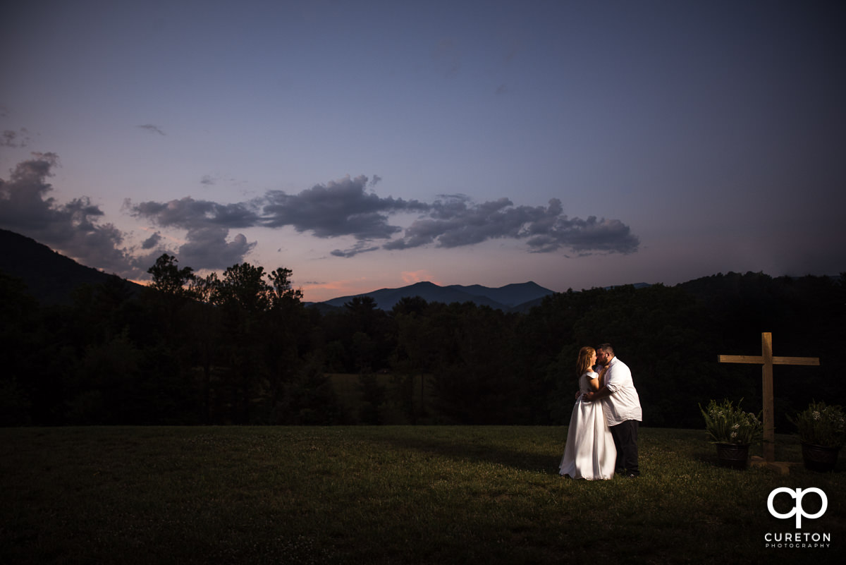 Bride and groom dancing an sunset after their Asheville NC outdoor wedding.