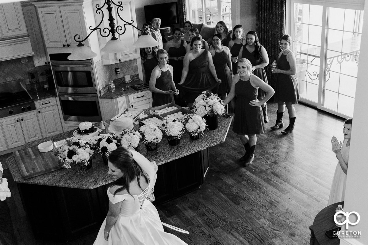 Bridesmaids seeing the bride for the first time.
