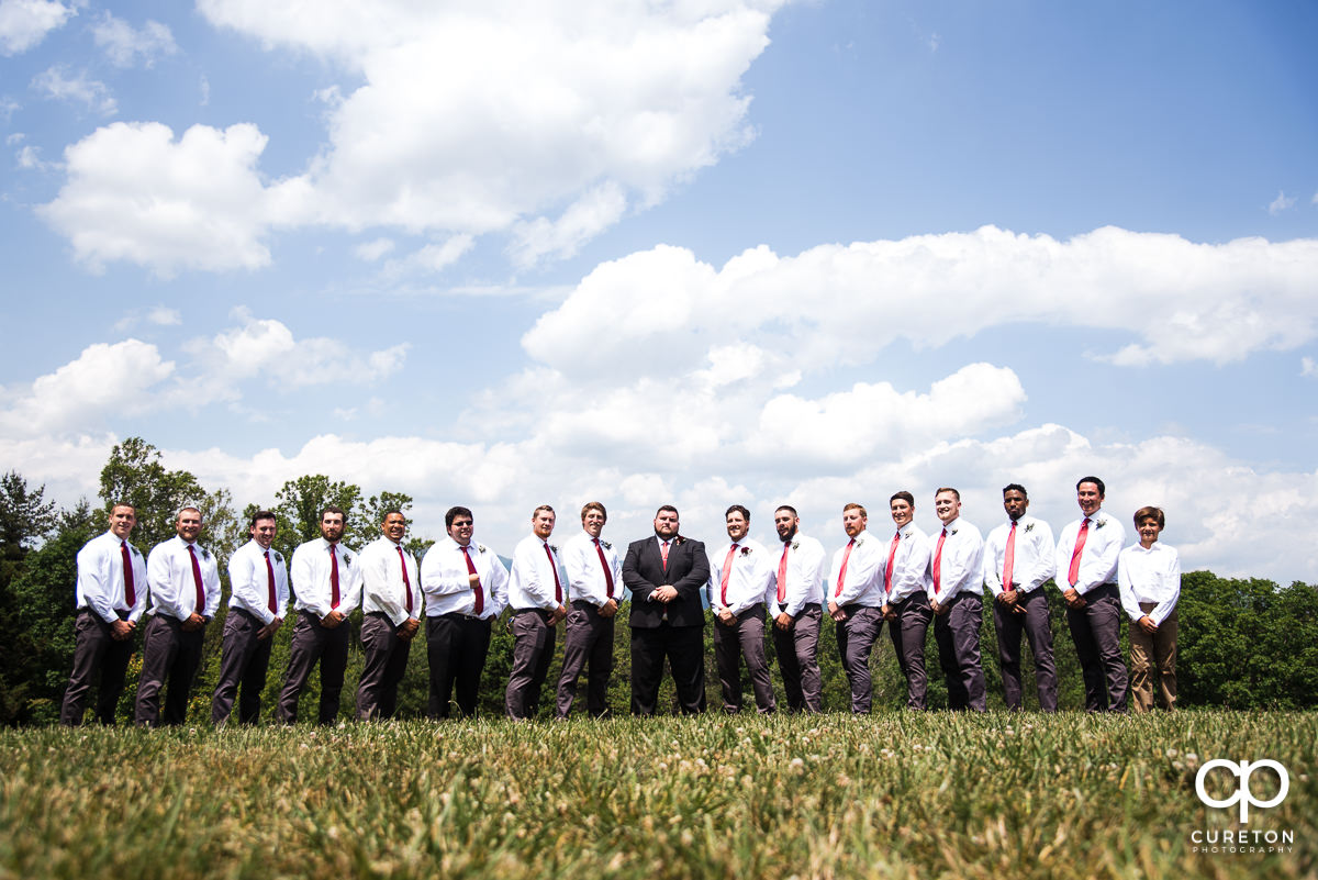 Groom and groomsmen in a field in Asheville,NC.