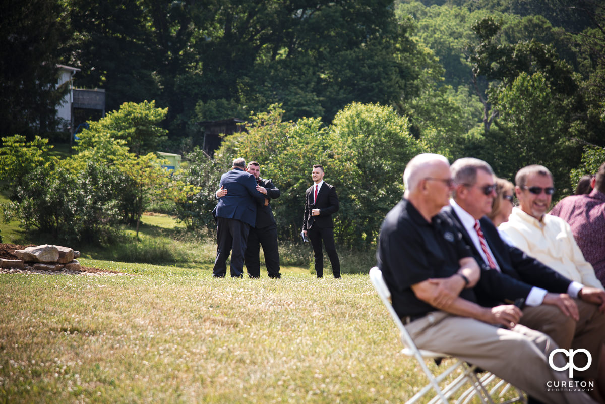 Groom hugging his dad before the ceremony.