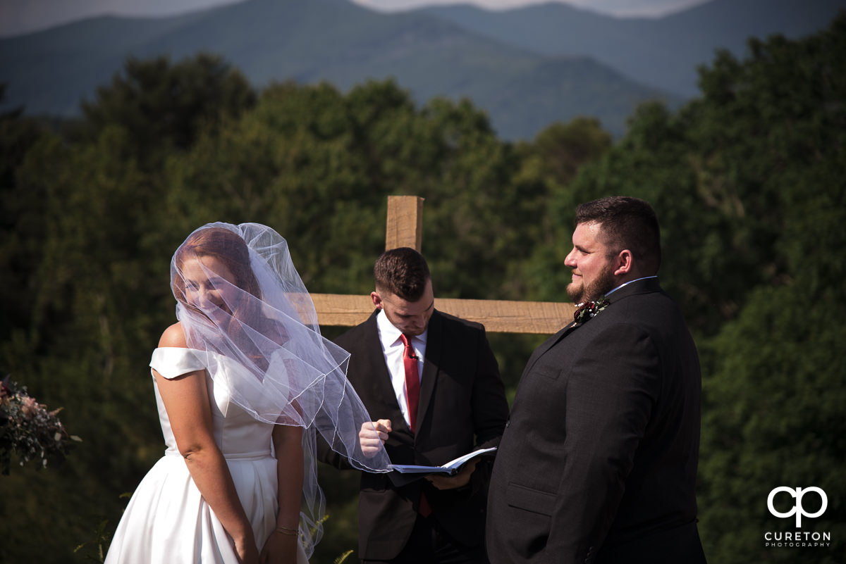 Bride laughing during the outdoor wedding ceremony in Asheville,NC.
