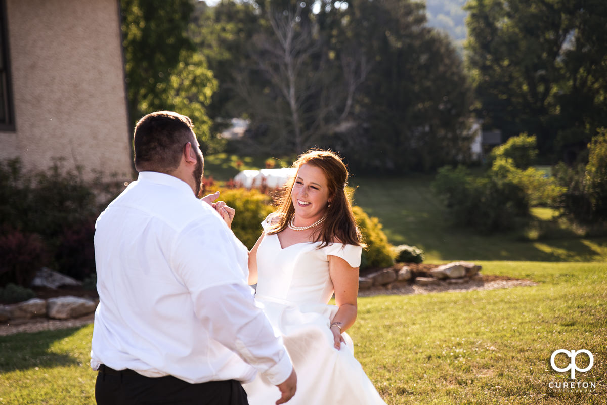 Bride smiling during the first dance at the Asheville,NC outdoor wedding reception.