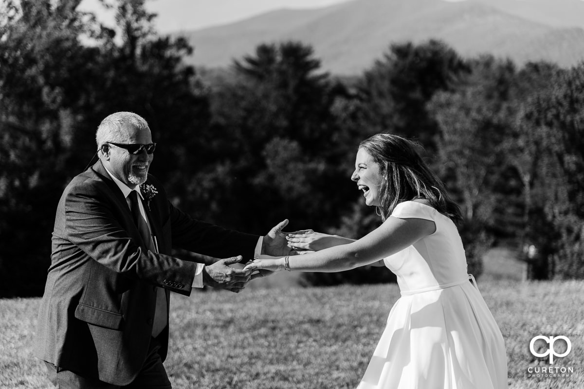 Bride dancing and laughing with her dad at the reception.