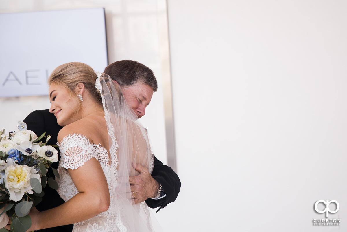 Bride hugging her dad during first look at Avenue in Greenville,SC.