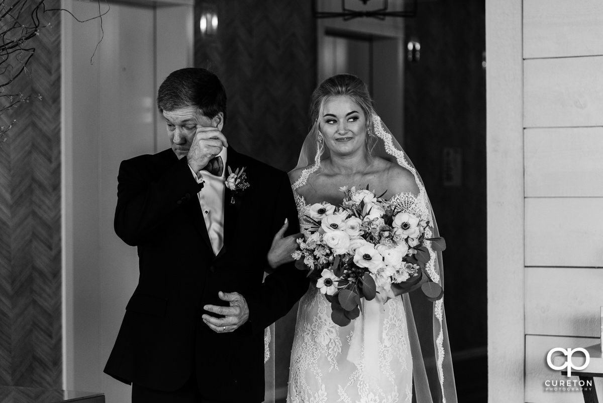 Bride and her father getting ready to walk down the aisle.