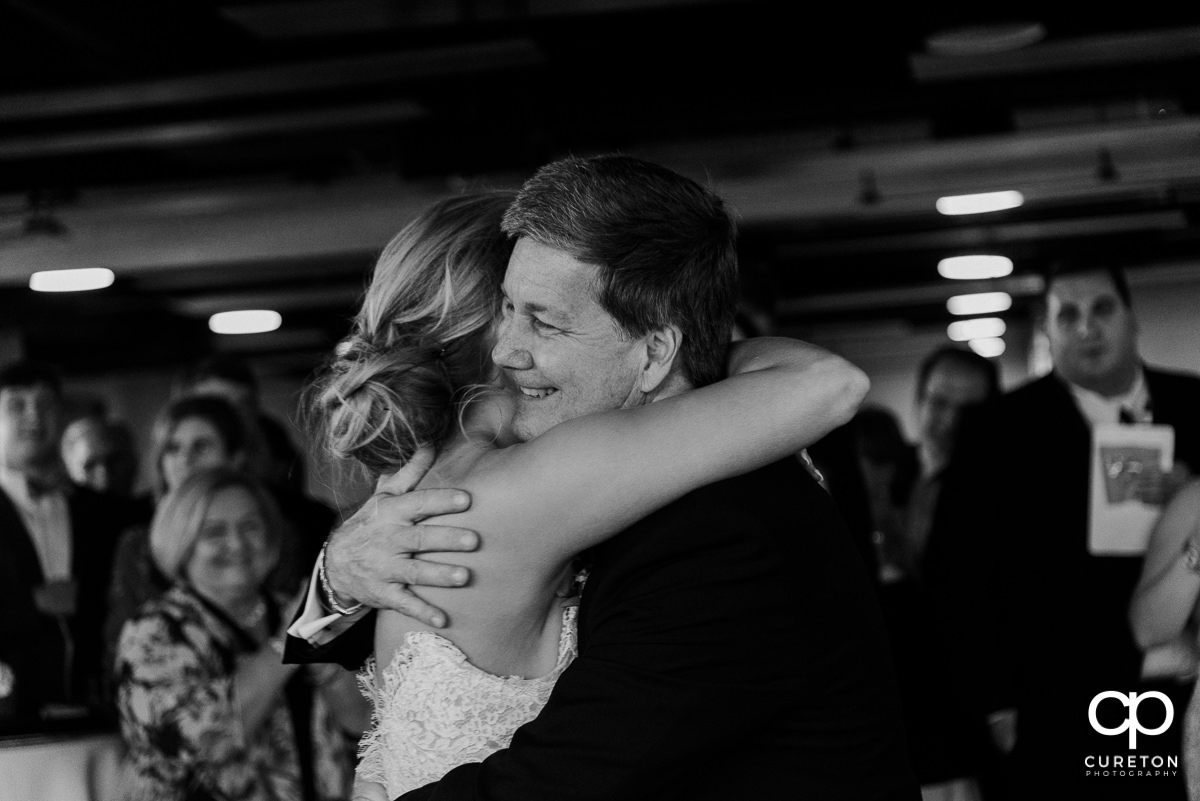 Bride hugging her dad.