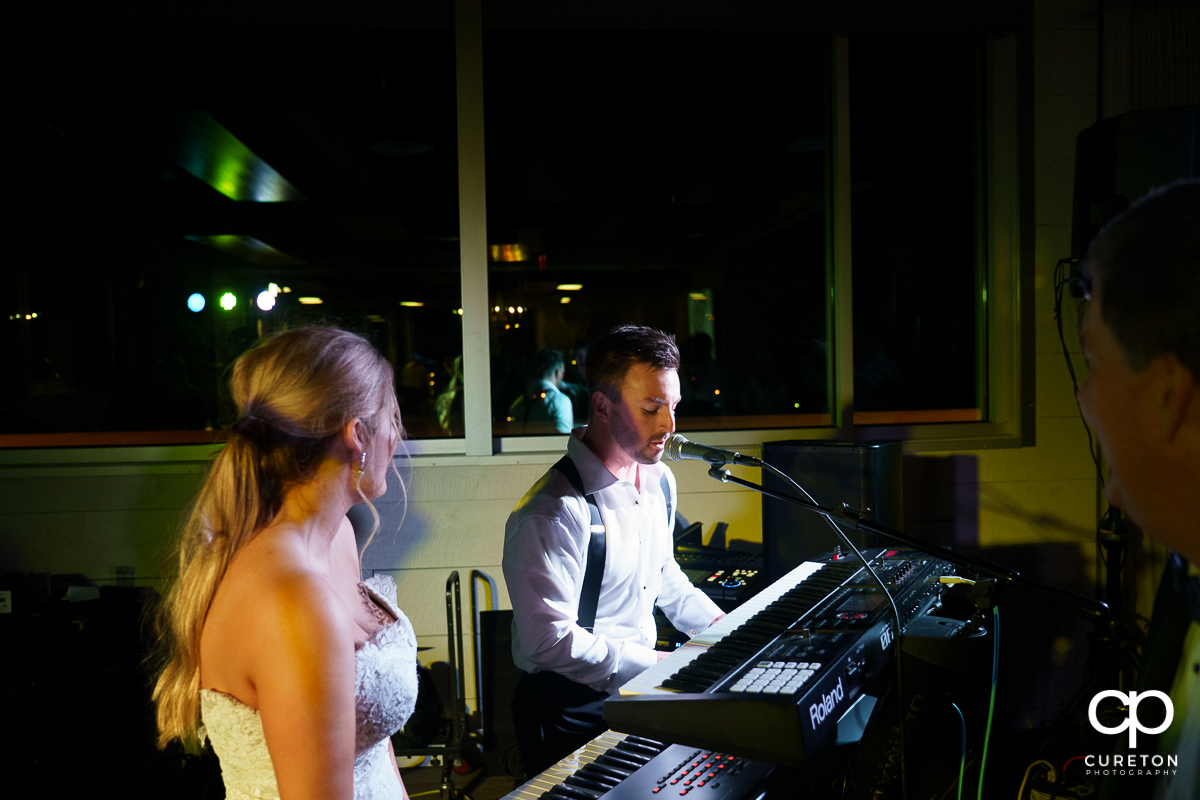 Groom singing to his bride at the reception.