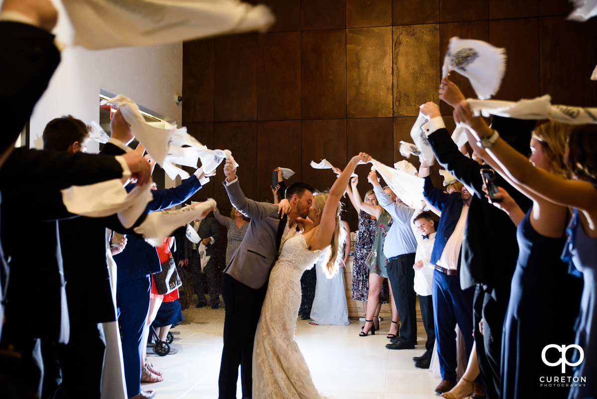 Bride and groom making an epic grand Gamecock exit at their wedding waiving towels as Sandstorm is played.