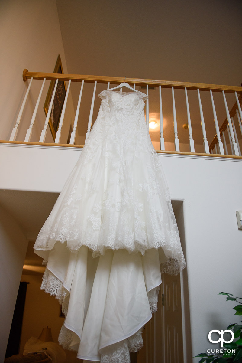 Bridal dress hanging on a staircase.