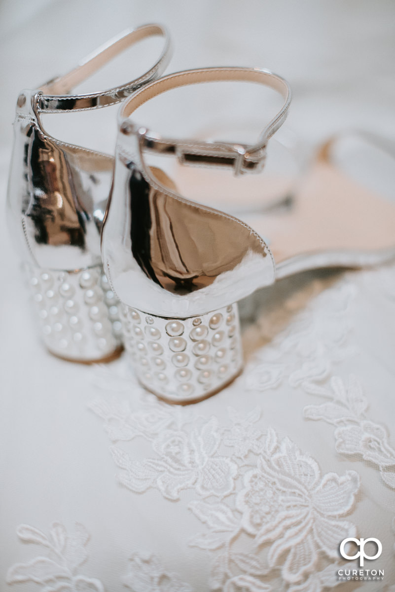 Bride's shoes sitting on her dress.