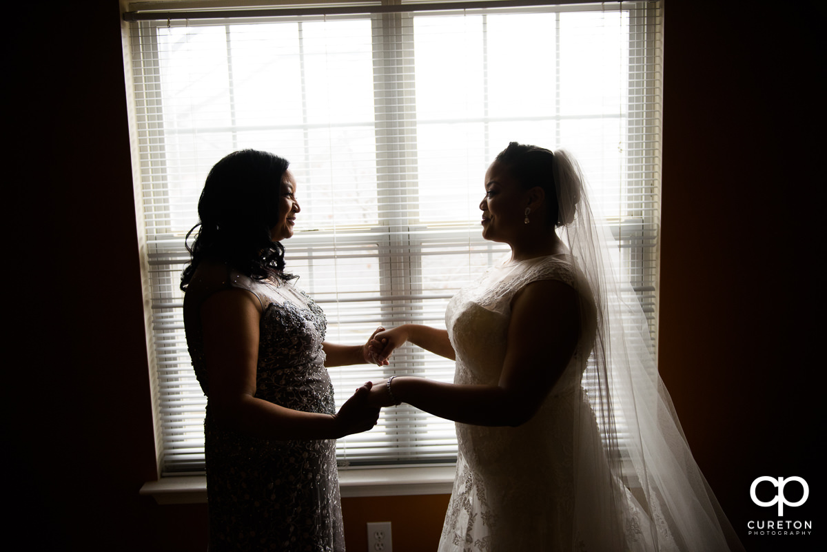 Bride and her mother sharing a moment before the ceremony.