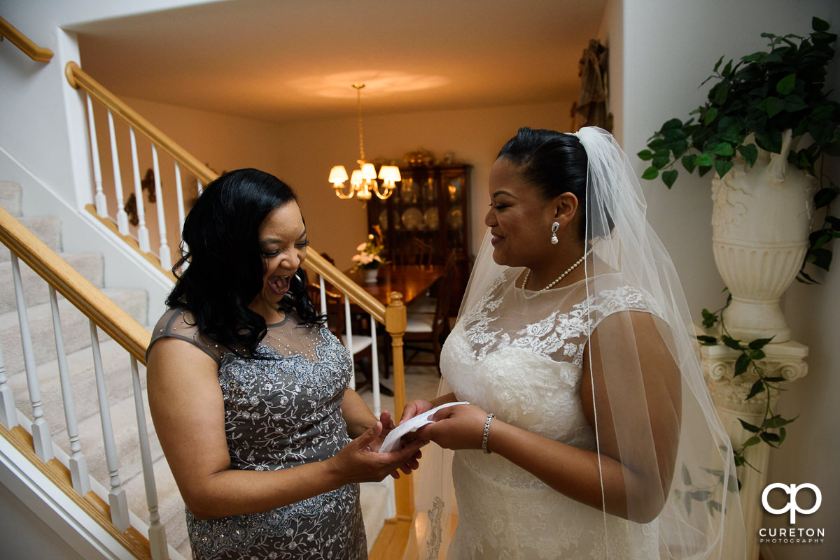 Bride giving her mother a gift.