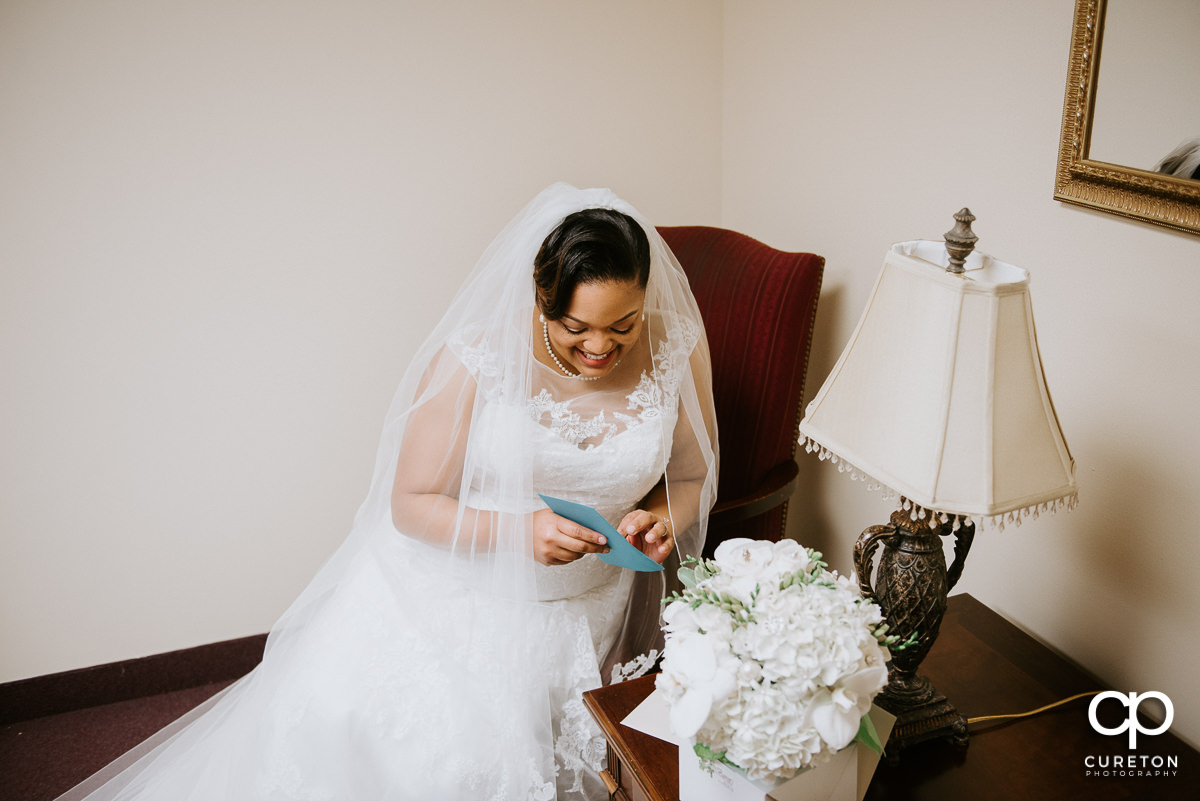 Bride opening a letter from her soon to be husband.