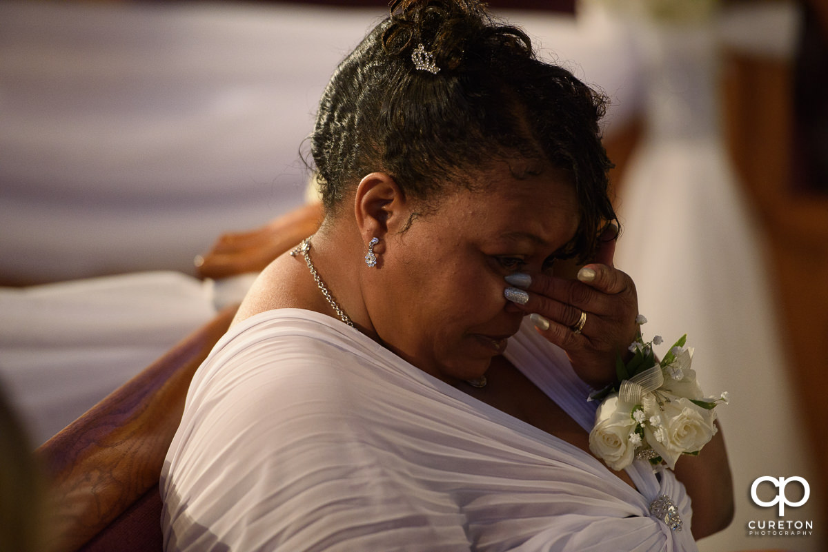 Groom's mother crying at wedding.