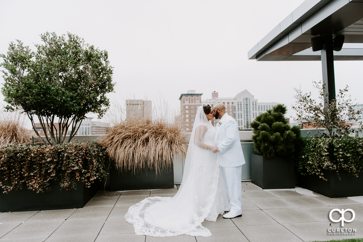 Bride and groom dancing on the rooftop patio at their Avenue Greenville wedding.