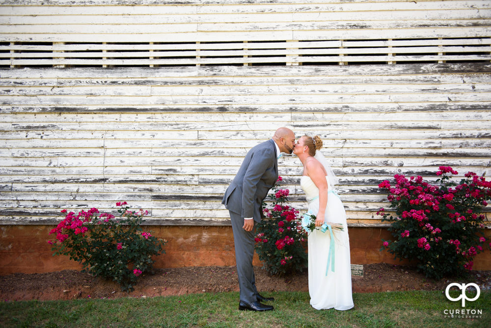 Bride and groom kissing after their wedding at The Barn at Forevermore Farms.