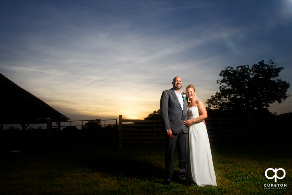Bride and groom at sunset after their rustic farm wedding.