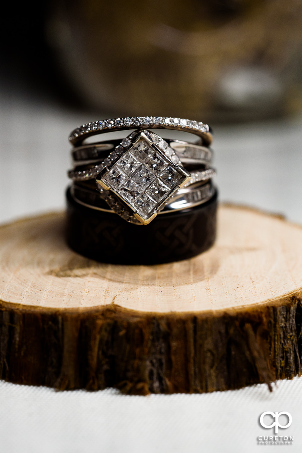 Closeup of wedding ring on a piece of a log.