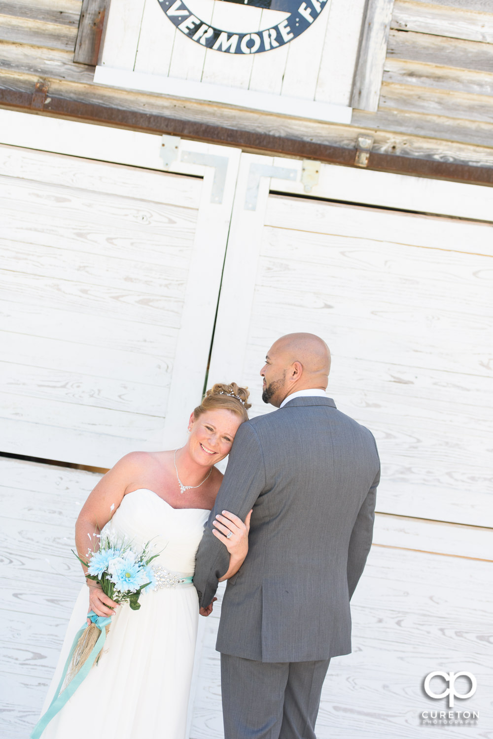 Bride and groom in front the Barn at Forevermore Farms.