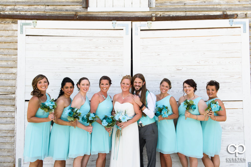 Bride and bridesmaids in front of the barn.