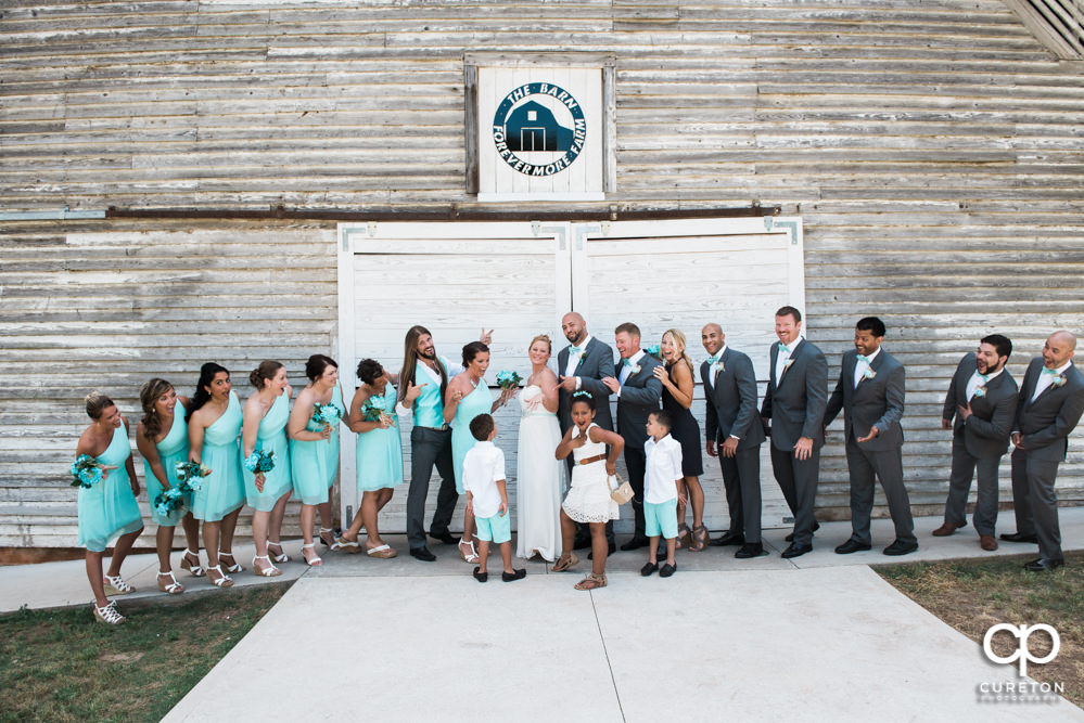 Wedding party in front of the barn door.