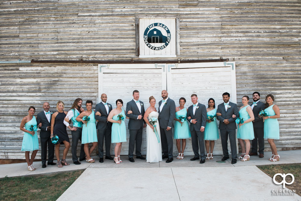 Wedding party in front of the barn door.