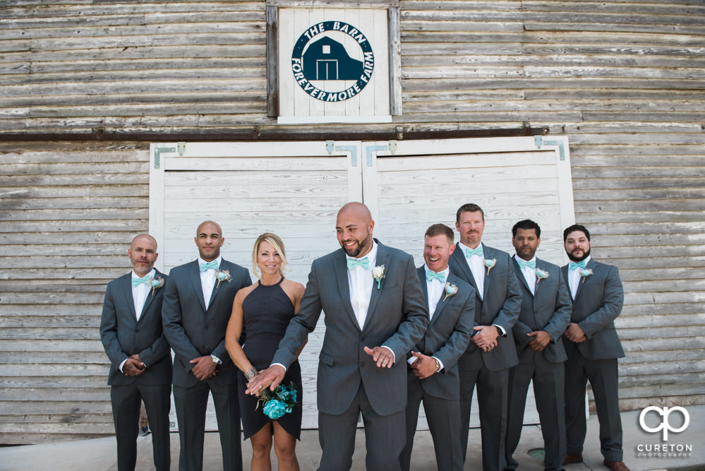 Groom and groomsmen in front of the barn.