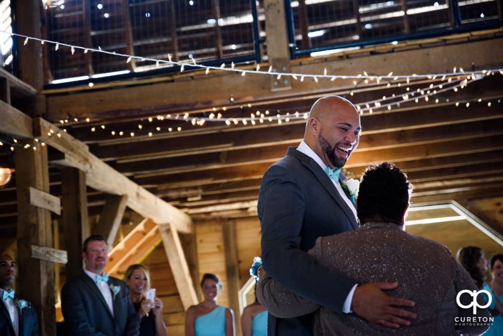 Groom and mother dance at their wedding reception at The Barn at Forevermore Farms.