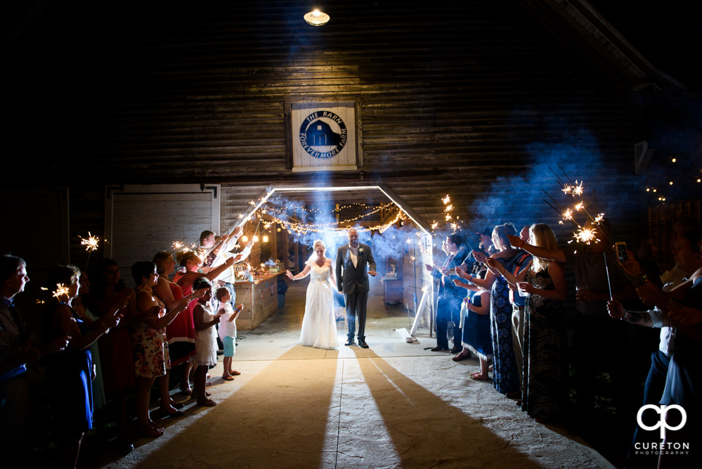 Sparkler grand exit after the wedding at The Barn at Forevermore Farms.