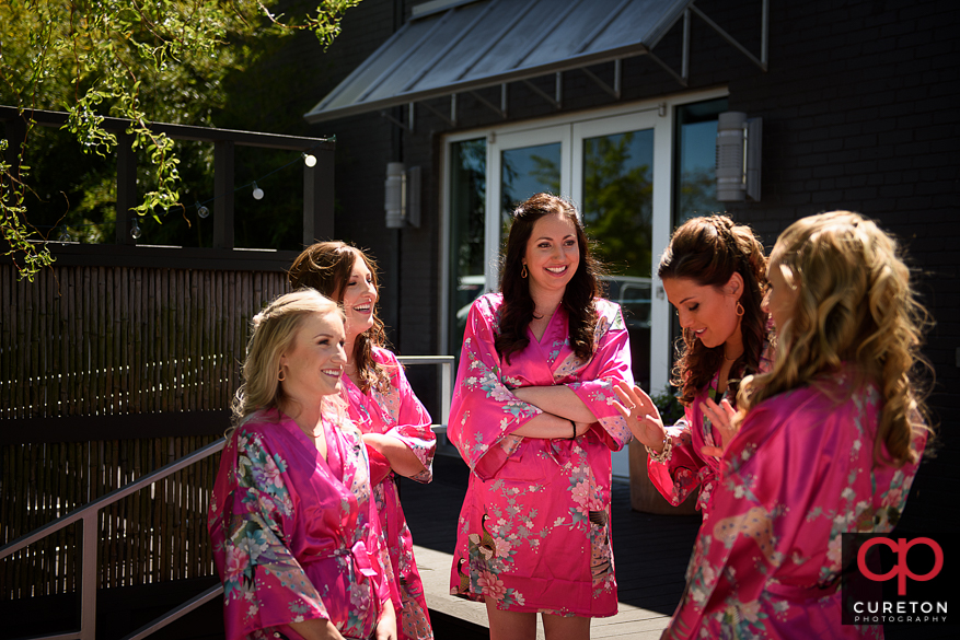 Bridesmaids in robes outside.