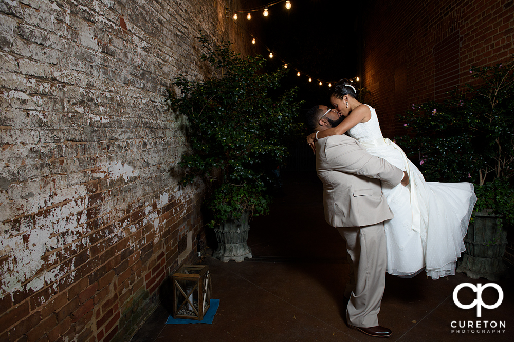 Groom lifting his bride their Bleckley Inn wedding.