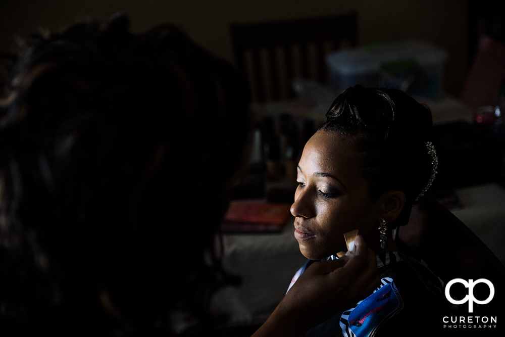 Bride getting her makeup applied.