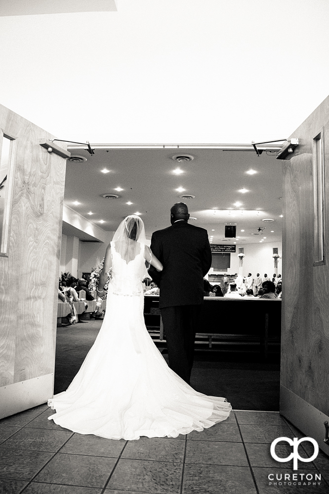 Bride and her father walking down the aisle.