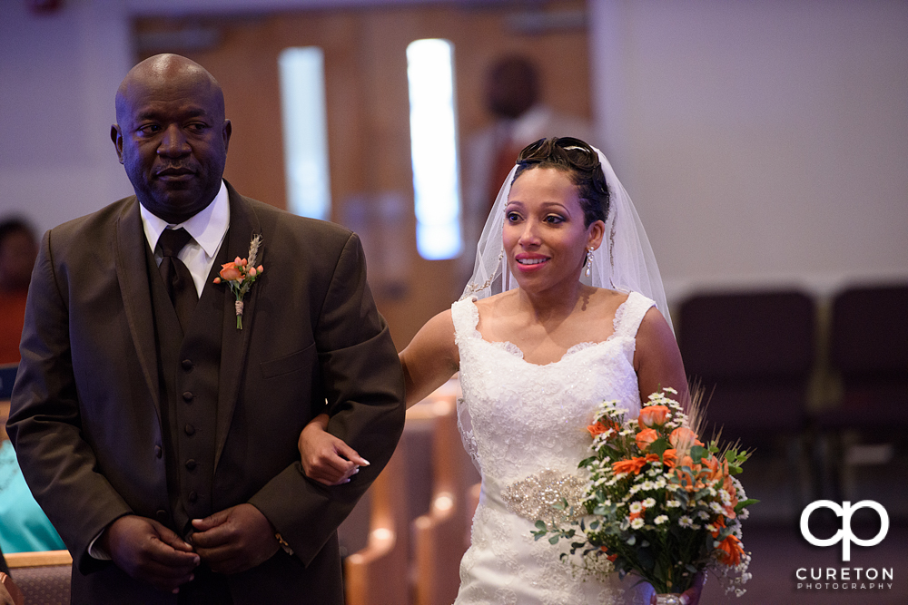 Bride and her father walking down the aisle.