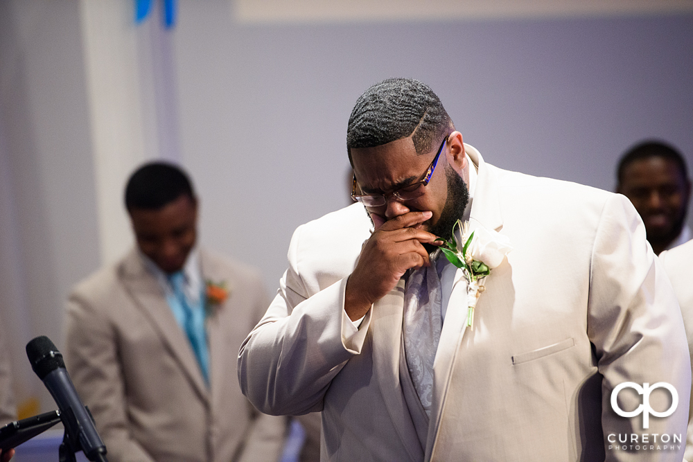 Groom cries when he sees his bride for the first time walking down the aisle.