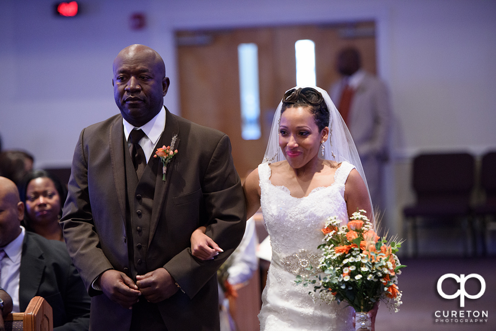 Bride and her father walking down the aisle.