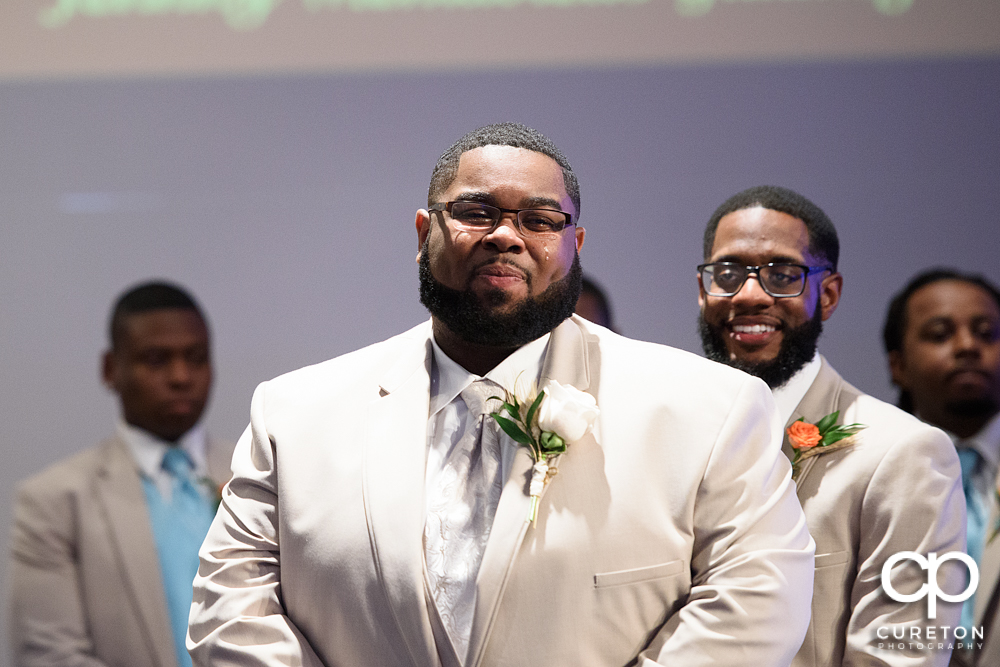 Groom with tears running down his face when he sees his bride.