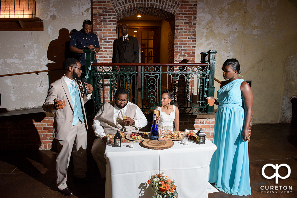 The best man and maid of honor giving toasts.