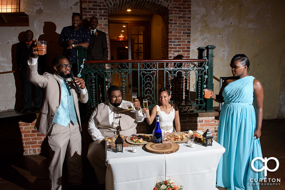 The best man and maid of honor giving toasts.