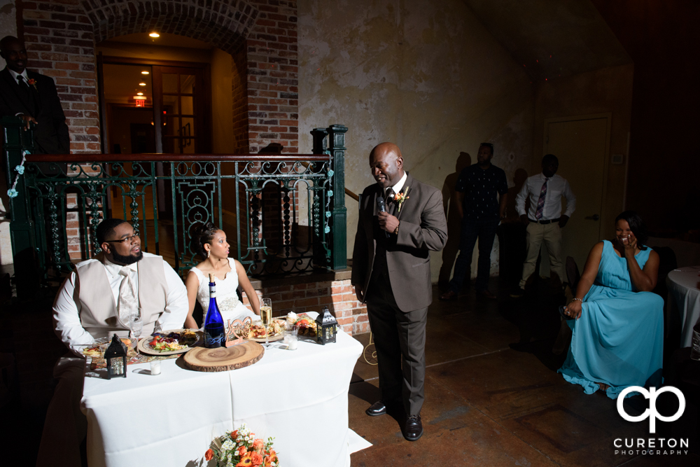 The best man and maid of honor giving toasts.