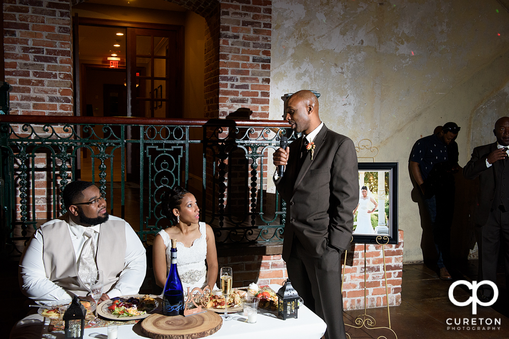 The best man and maid of honor giving toasts.