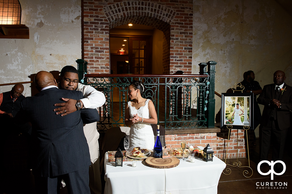 Groom hugging a wedding guest.