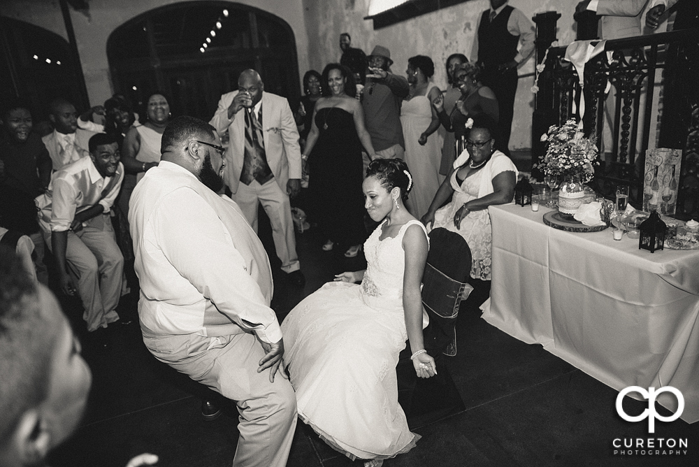 Groom taking off the garter.